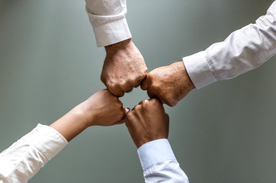 Four Person Hands In White Dress Shirts