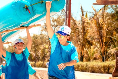 Men In Blue Holding Blue Boat