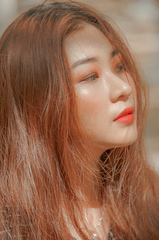 Woman With Red Hair And Orange Lipstick Taking Self Photo