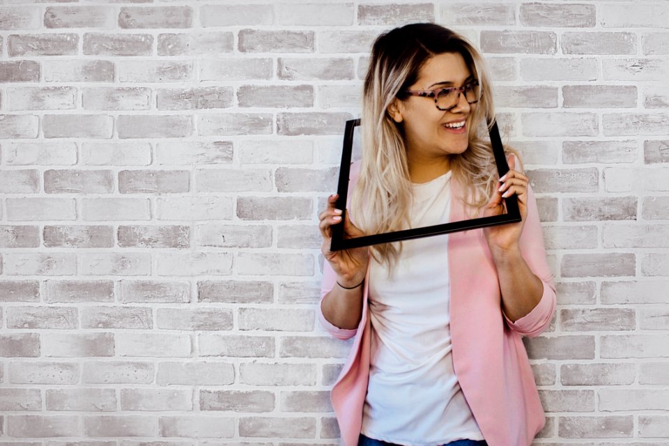 Woman Holding Black Photo Frame