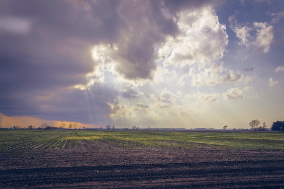 Photo Of Green Field Under Cloudy Sky