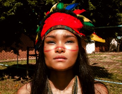 Woman Wearing Red And Black Feather Hat photo