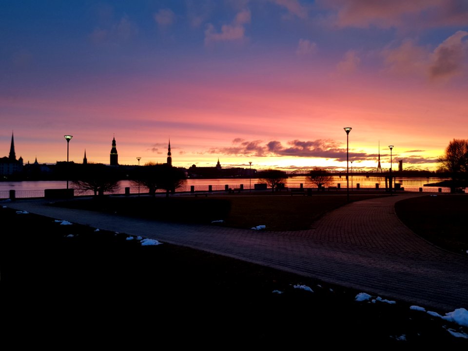 Cloudy Blue And Orange Sky Over Park