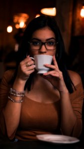 Woman Wearing Brown Scoop-neck Quarter-sleeved Top Holding White Ceramic Mug photo