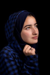 Woman In Black And Blue Plaid Headscarf photo