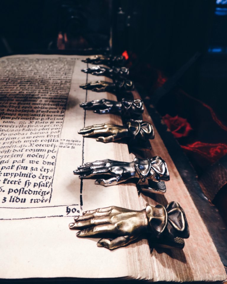 Close Up Photo Of Black And Brown Metal Hand Book Mark