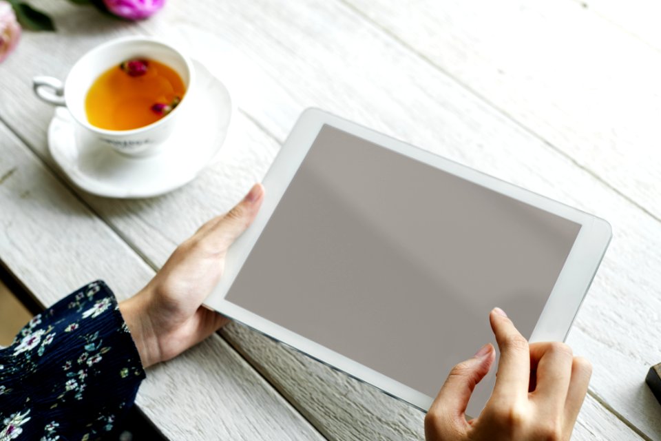 White Ipad On Hand