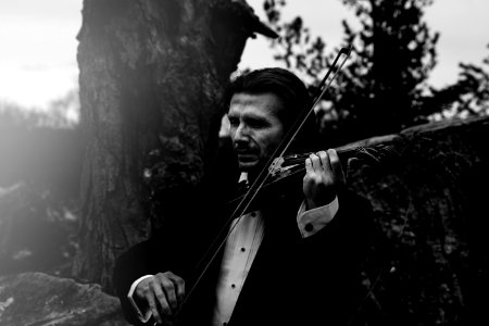 Grayscale Photo Of Man Playing Violin photo