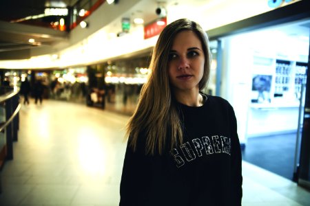 Woman Wearing Black Supreme Sweater photo