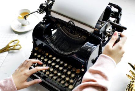 Woman Uses Black Typewriter photo