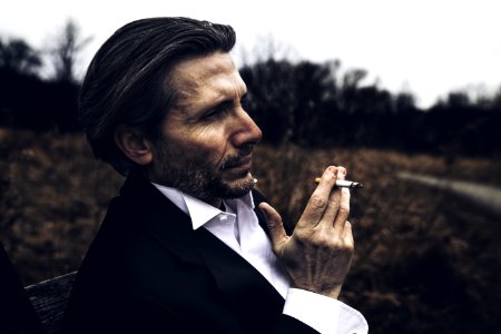 Photo Of Man Holding A Cigarette photo