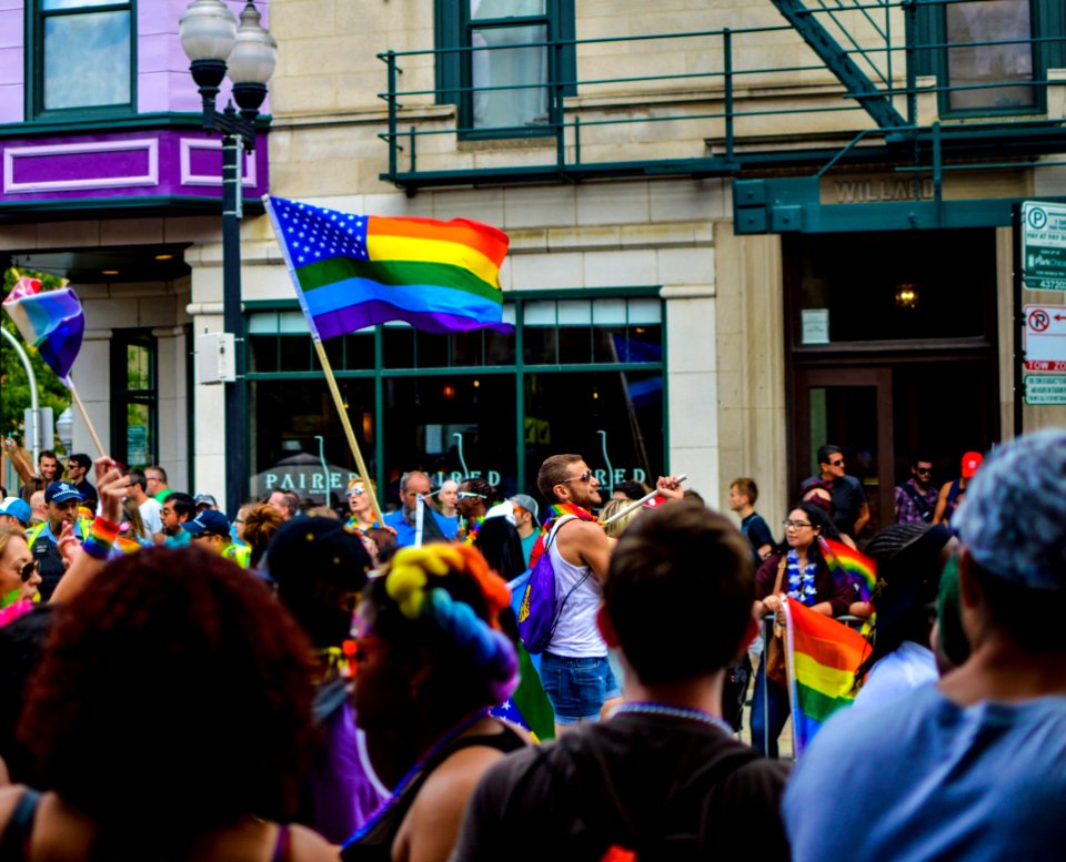 People Gathered Near Building Holding Flag At Daytime