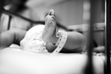 Grayscale Photography Of Baby Laying photo