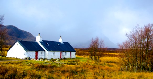 White And Blue House Under Cumulus Nimbus Clouds photo