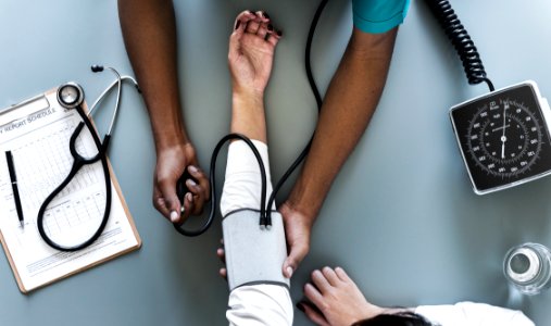 Person Using Black Blood Pressure Monitor photo