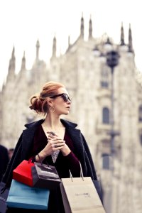Shallow Focus Photography Of Woman Holding Assorted-color Paper Bags