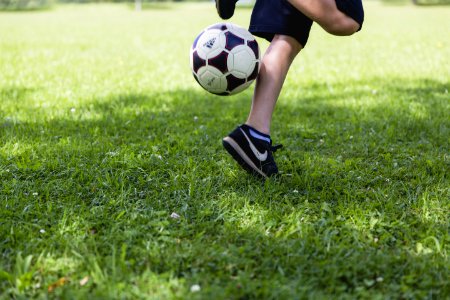 Person Wearing Black Nike Low-tops Sneakers Playing Soccer photo