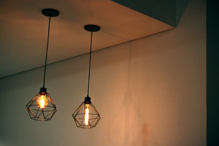 Two Black Pendant Lamp On White Concrete Ceiling photo
