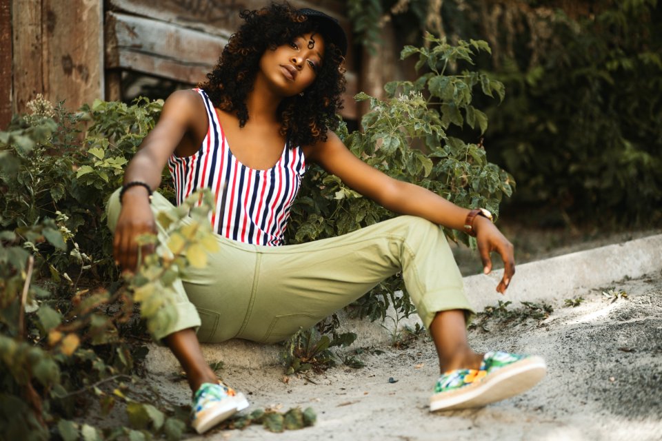 Photo Of A Woman Sitting On Pavement