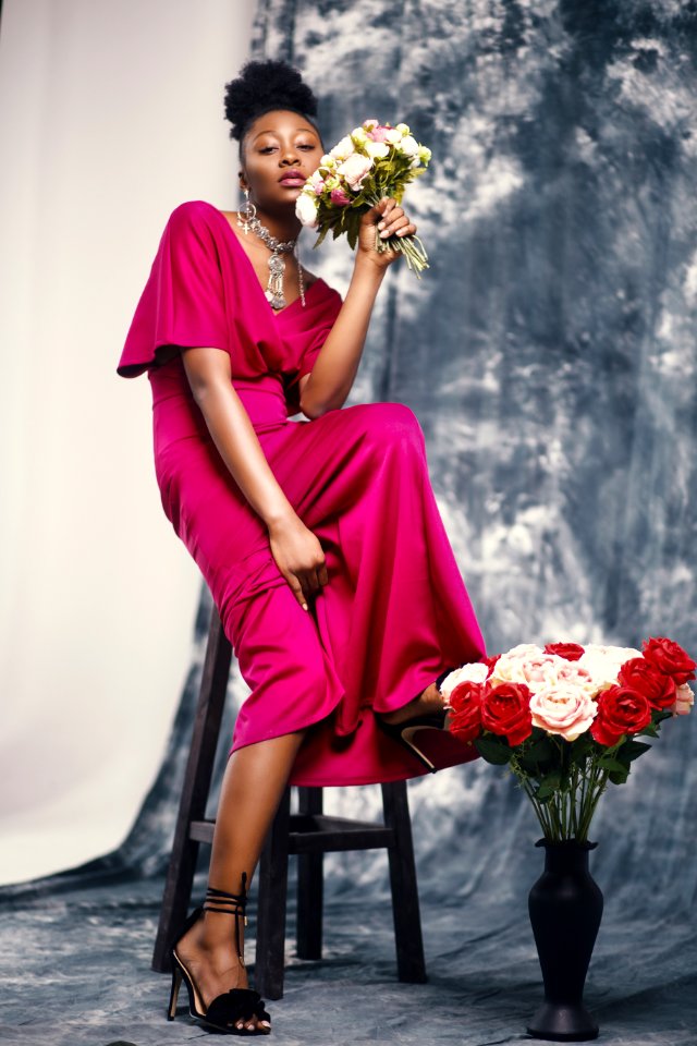 Woman In Pink Maxi Dress Holding Bouquet Of Flowers photo