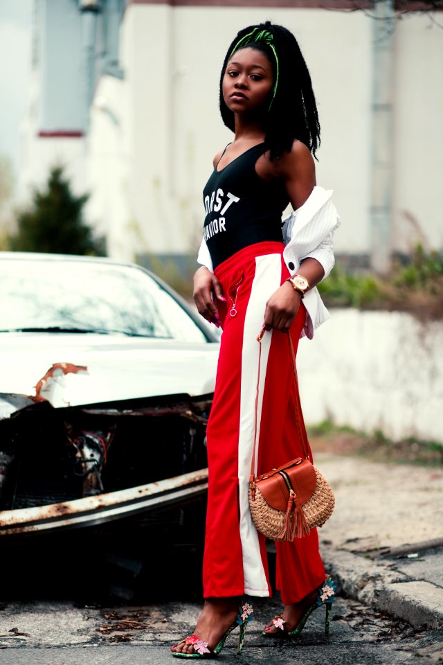 Womens Black Tank Top And Red Track Pants Walking On Street