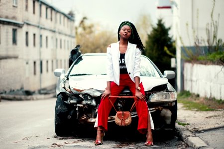 Woman Sitting In Front Of The Car