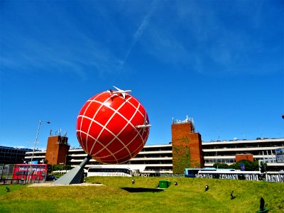 Red And White Globe Statue Near Brown And White Concrete Building photo