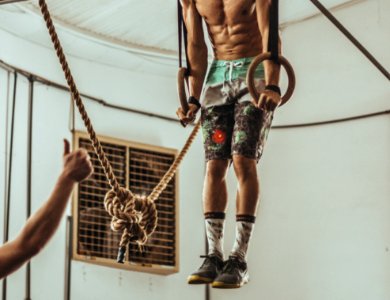 Man Wearing Teal And Black Floral Board Shorts