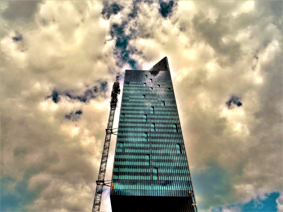 Black High-rise Building With White Clouds