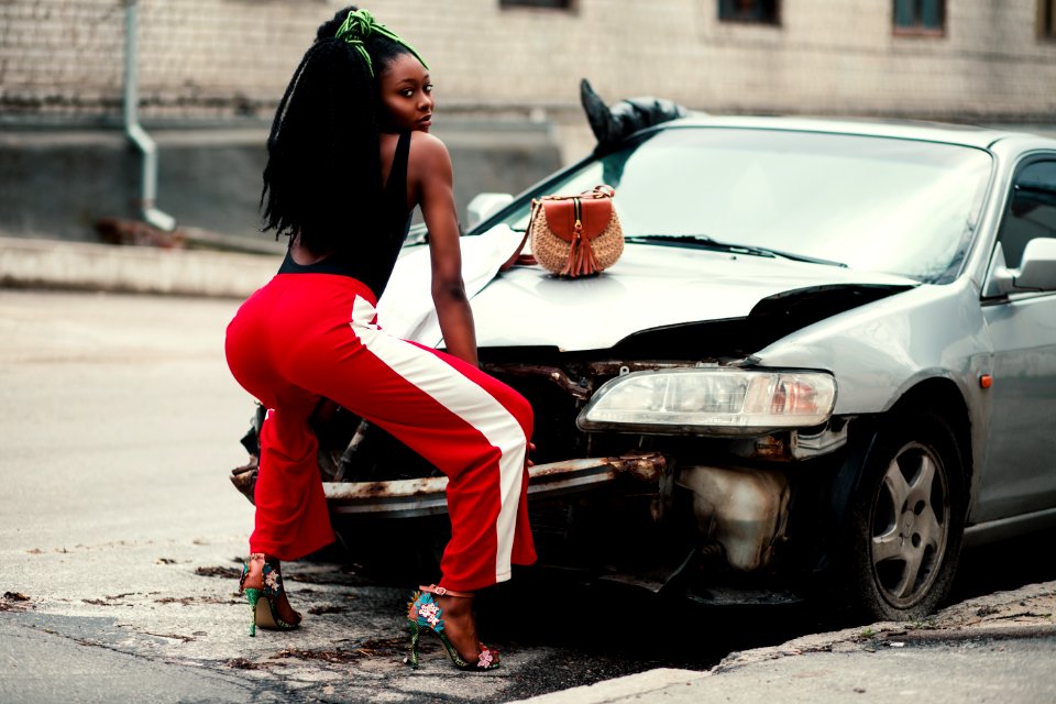 Photograph Of Woman About To Twerk In Front Of Vehicle