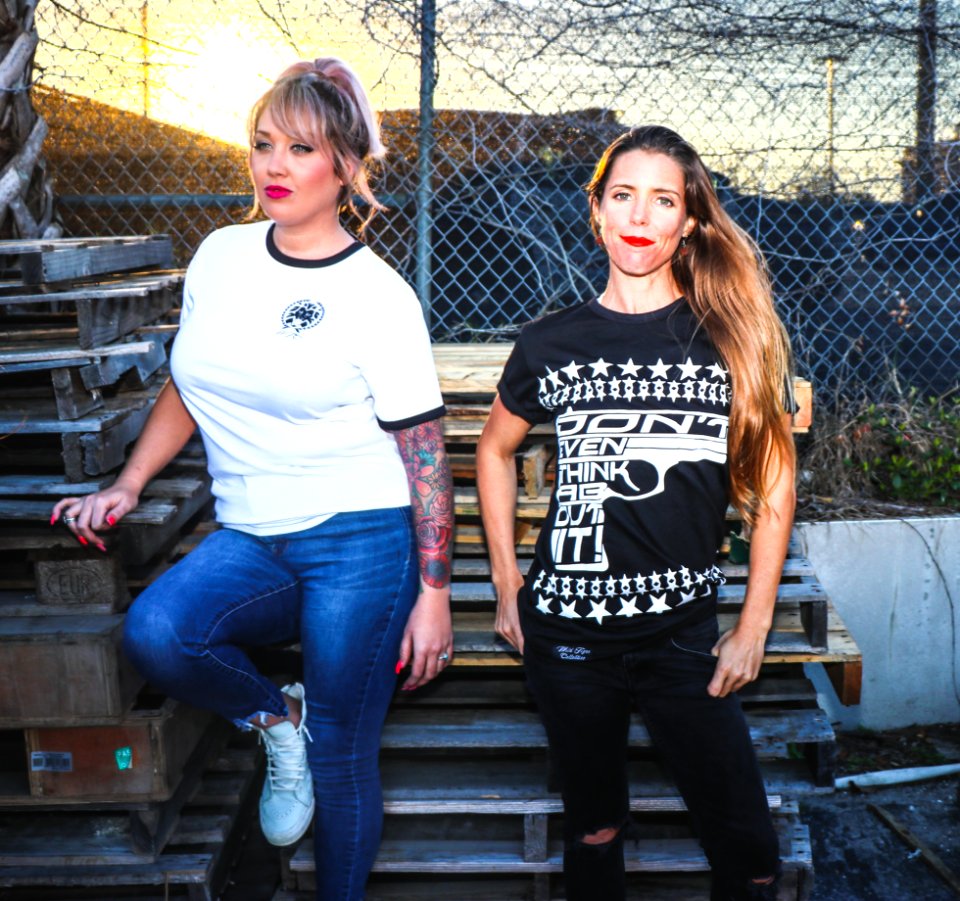 Two Women Taking Picture Near Pallets
