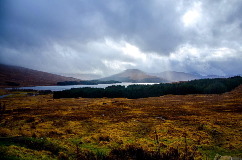 Mountain Beside Body Of Water Under White Clouds