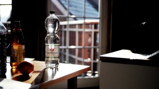 Glass Bottle On Brown Wooden Table photo