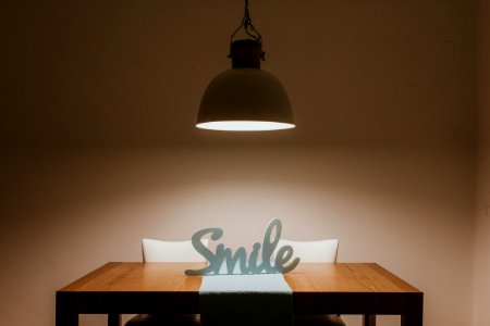 White Smile Cutout Signage On Table