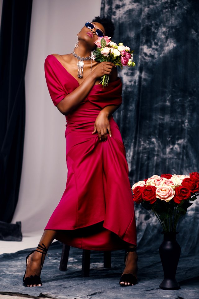 Woman In Red Dress Holding Flower