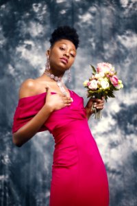 Woman In Pink Off-shoulder Dress Holding Pink And White Flower Bouquet photo