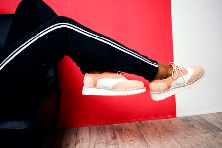 Person Wearing Pink-and-white Low-top Sneakers And Black Track Pants photo