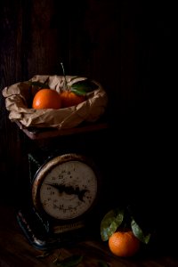 Three Orange Fruits And Analog Scale photo