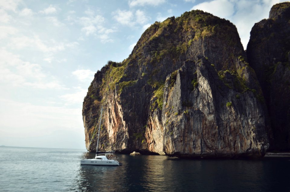 White Sailing Boat Beside Mountain photo