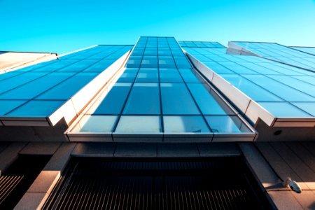 Low Angle Photography Of Blue Glass Building photo