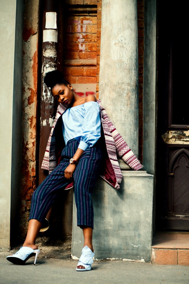 Woman Sitting On Concrete Column