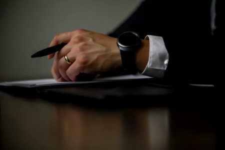 Person Holding Black Pen photo