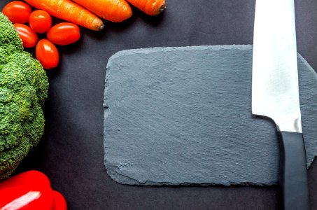 Black Handle Knife Near The Carrots