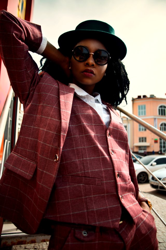 Woman In Maroon Buttoned Coat Wearing Black Hat