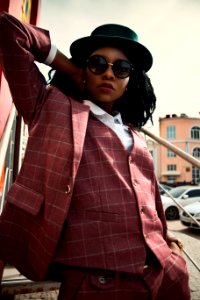 Woman In Maroon Buttoned Coat Wearing Black Hat photo