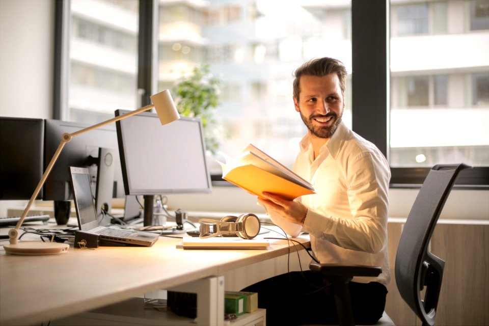 Photo Of Man Holding A Book photo