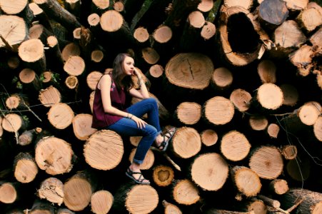 Photography Of A Woman Sitting On A Log photo