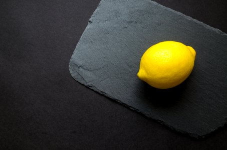 Photo Of Yellow Lemon On Gray Surface photo