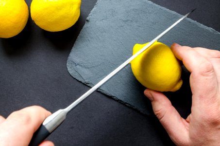 Photo Of Person Slicing Lemon photo