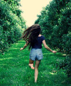 Photo Of A Woman Running On Green Grass photo